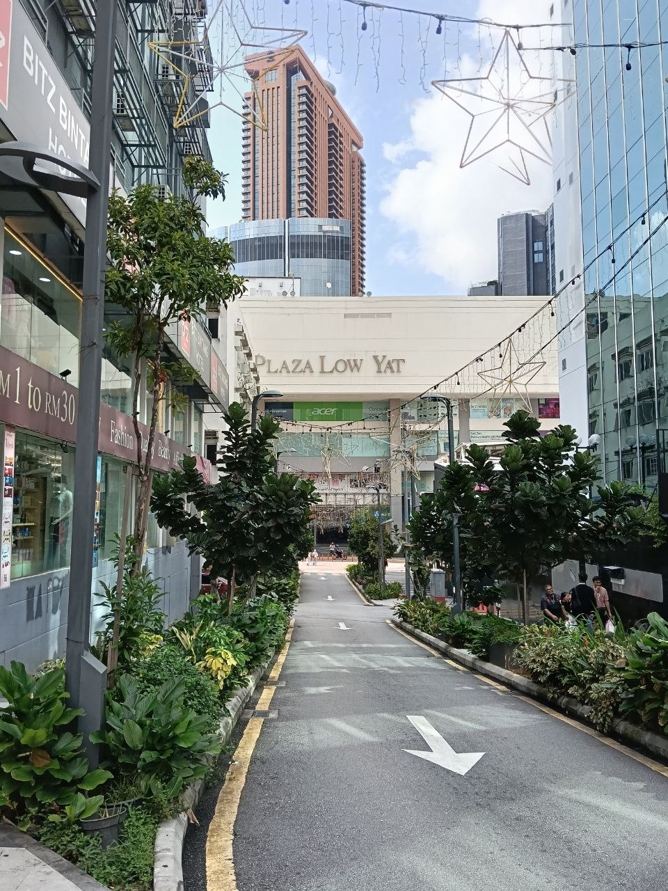 Plaza Low Yat street entrance with KL Tower visible in the background on a busy Bukit Bintang street