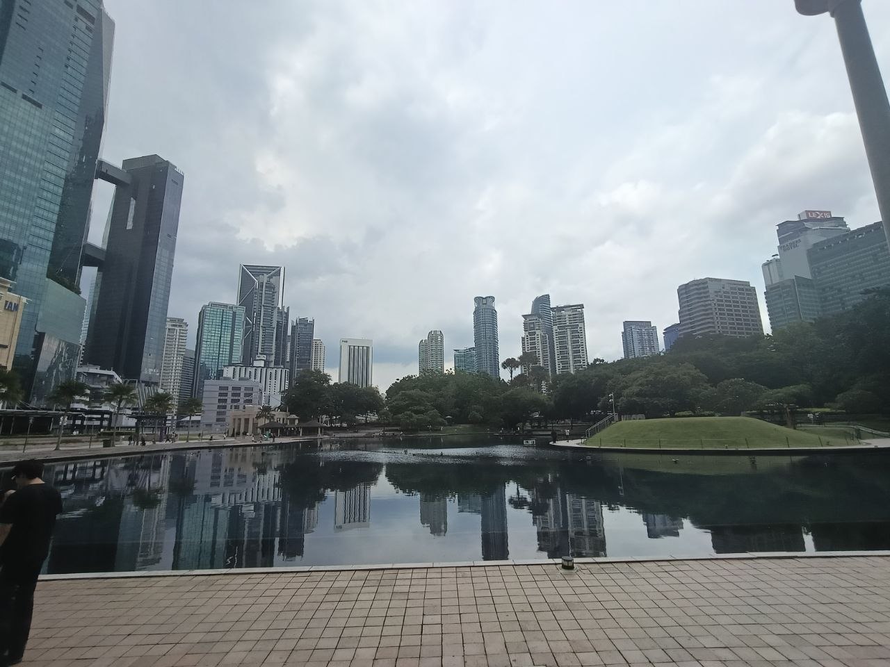 KL city skyline reflecting perfectly in the lake at KLCC Park