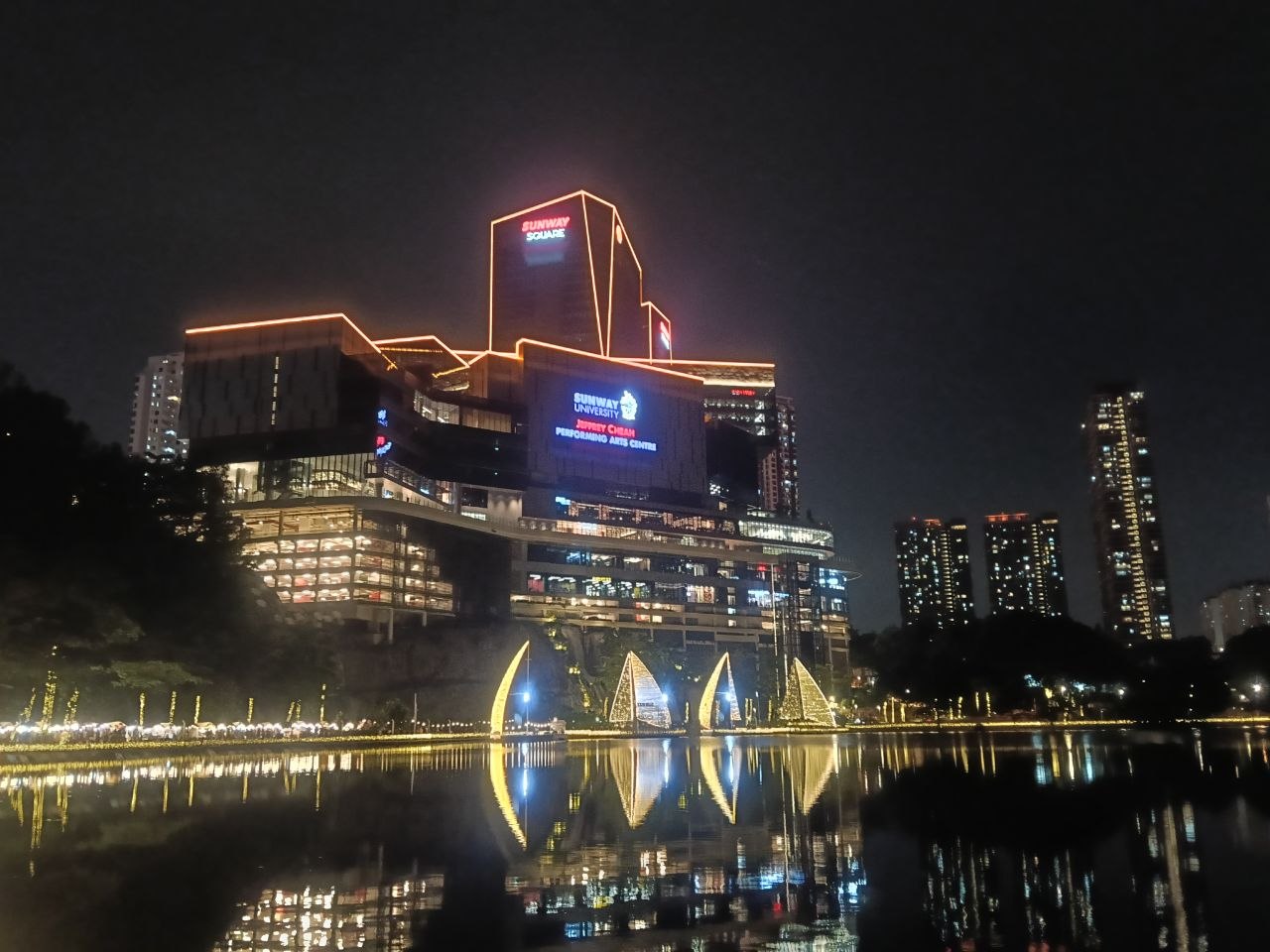 Gorgeous night view of Sunway Square lit up reflected in the lake
